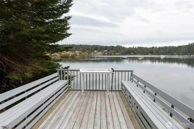 a view of balcony with wooden floor and lake view