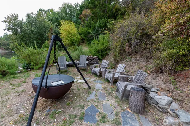 a view of a backyard with plants and lake view