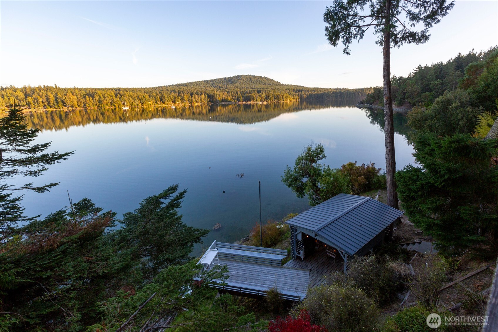 457 White Point Road Friday Harbor, WA 98250 - Photo 36 of 39 a wooden bench sitting in front of a house with a lake view