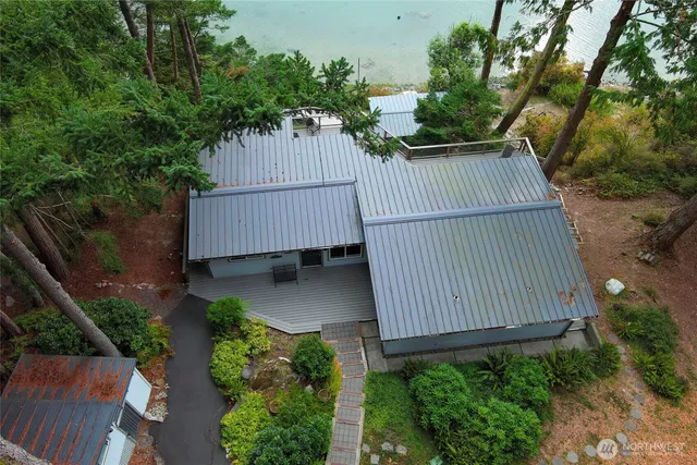 an aerial view of a house with a yard and garden