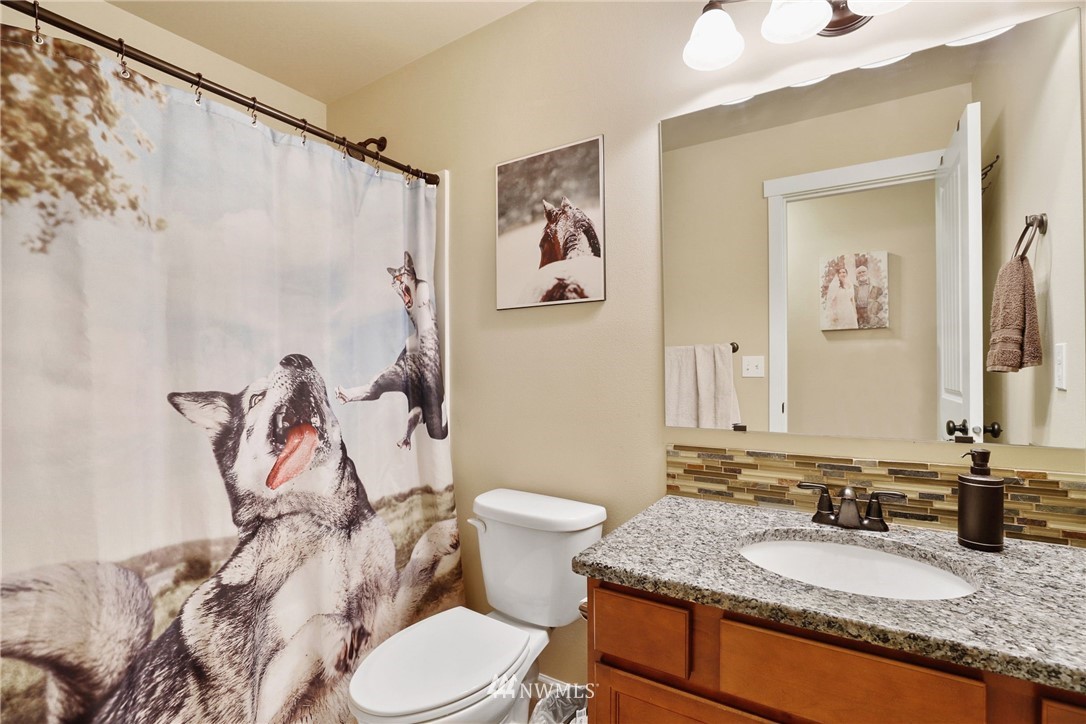 9327 179th Way Southwest Rochester, WA 98579 - Photo 15 of 20 a bathroom with a granite countertop sink mirror and toilet