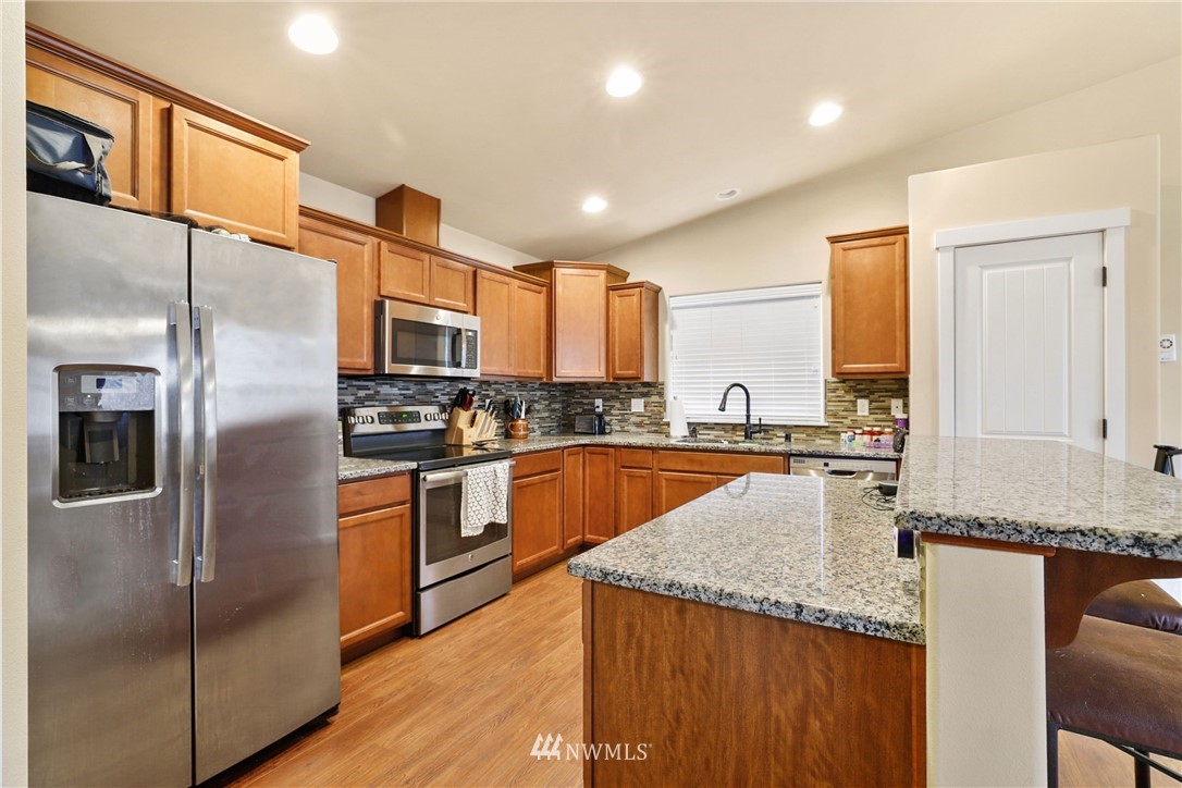 9327 179th Way Southwest Rochester, WA 98579 - Photo 4 of 20 a kitchen with stainless steel appliances granite countertop a refrigerator a stove and a sink
