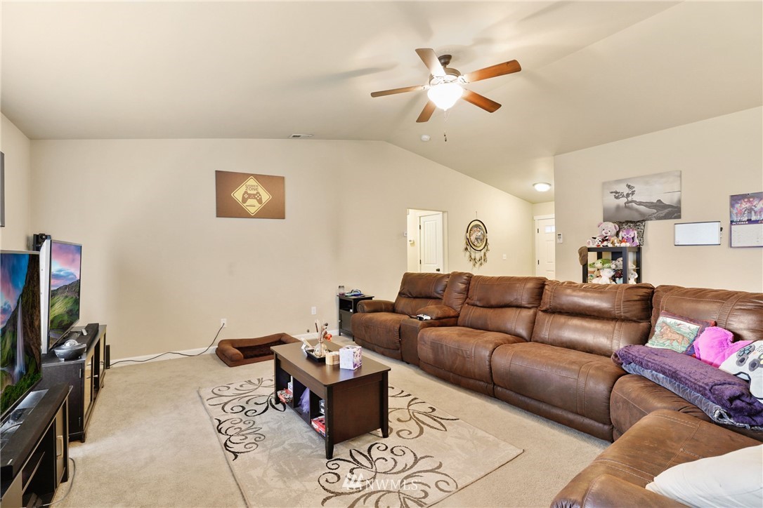 9327 179th Way Southwest Rochester, WA 98579 - Photo 6 of 20 a living room with furniture and a flat screen tv