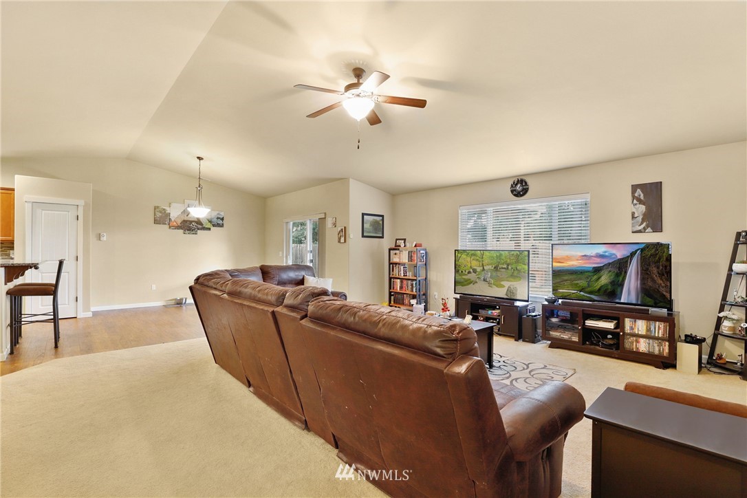 9327 179th Way Southwest Rochester, WA 98579 - Photo 7 of 20 a living room with furniture a fireplace and a flat screen tv