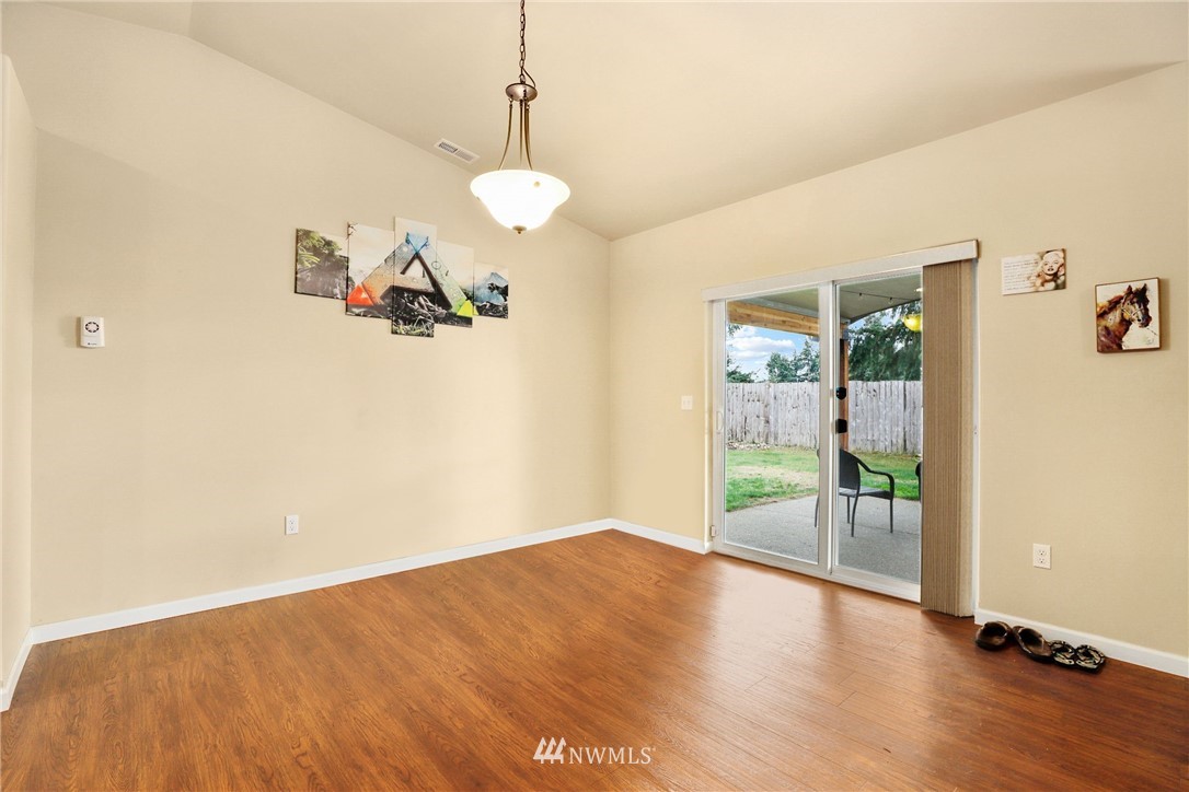 9327 179th Way Southwest Rochester, WA 98579 - Photo 8 of 20 a view of an empty room with wooden floor and a window