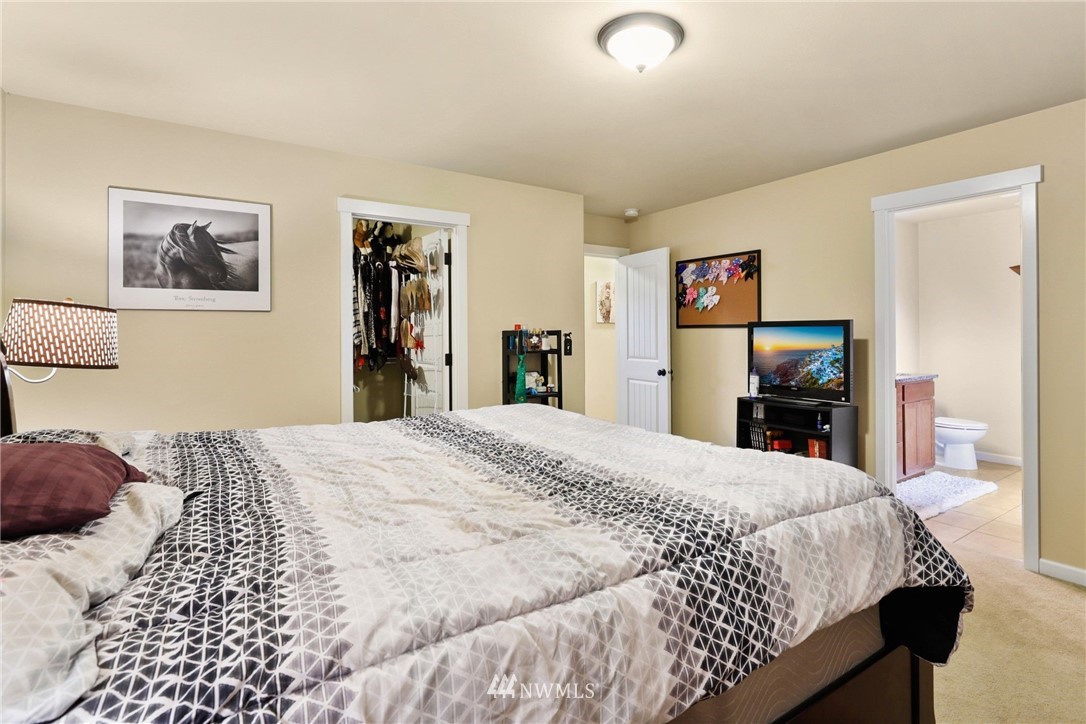 9327 179th Way Southwest Rochester, WA 98579 - Photo 10 of 20 a bedroom with a large bed and a dresser