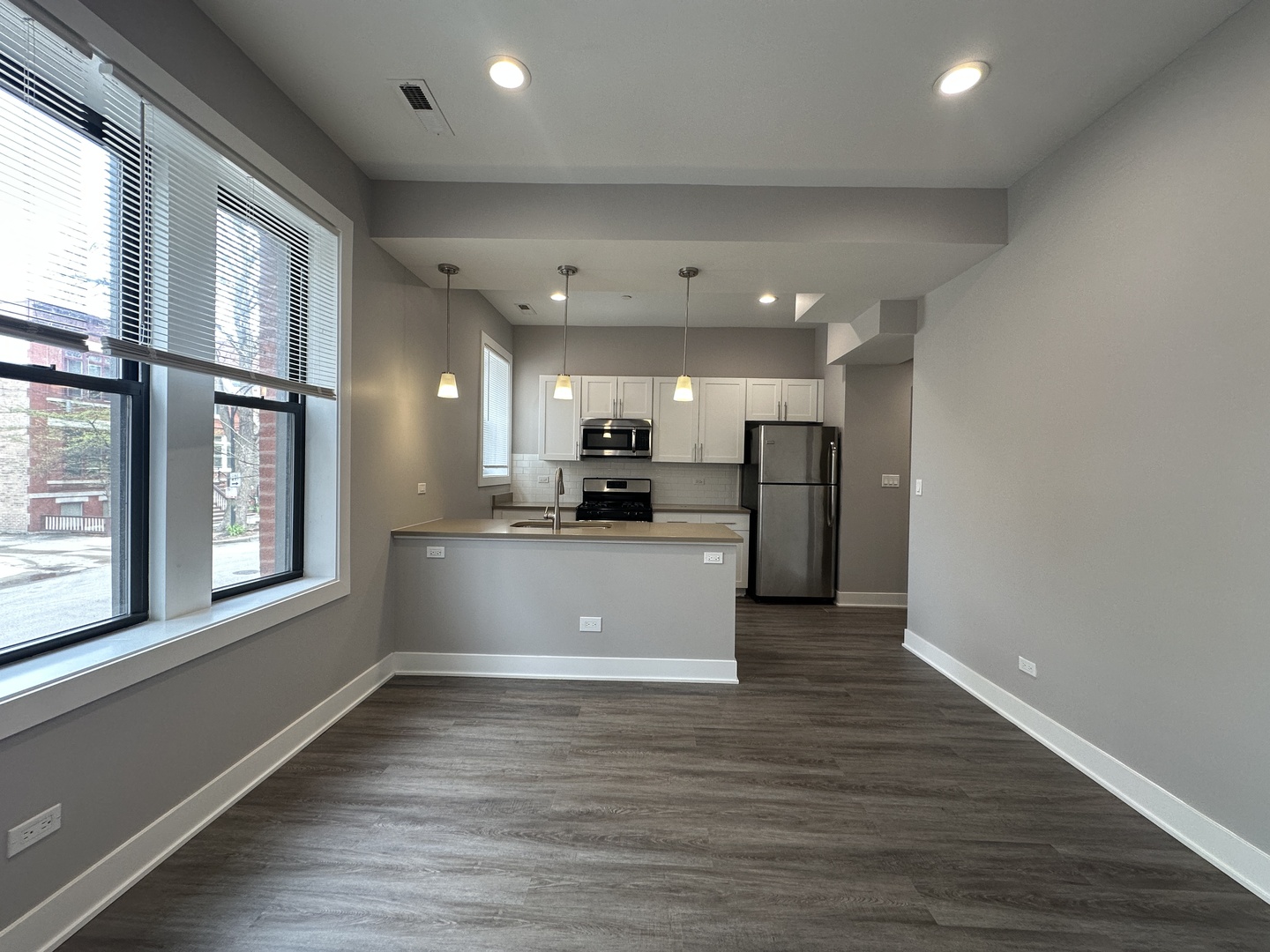 2053 West Iowa Street, Unit 1 Chicago, IL 60622 - Photo 3 of 12 a view of kitchen with stainless steel appliances refrigerator oven large window and wooden floor