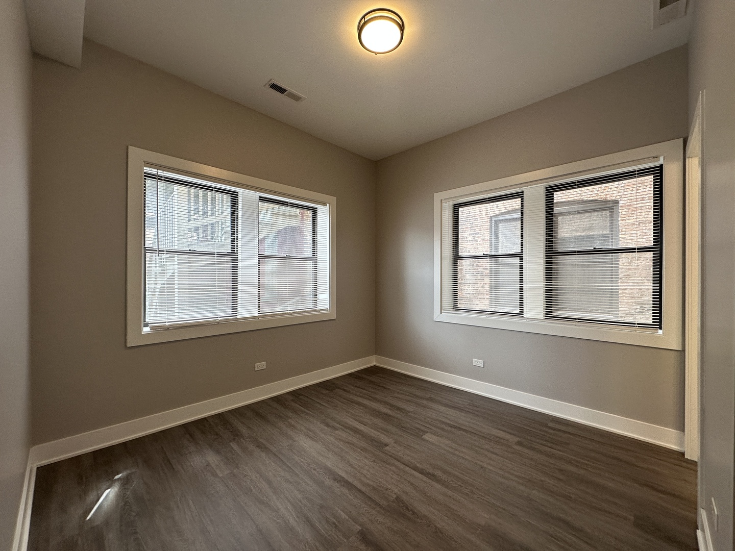2053 West Iowa Street, Unit 1 Chicago, IL 60622 - Photo 9 of 12 a view of an empty room with wooden floor and a window