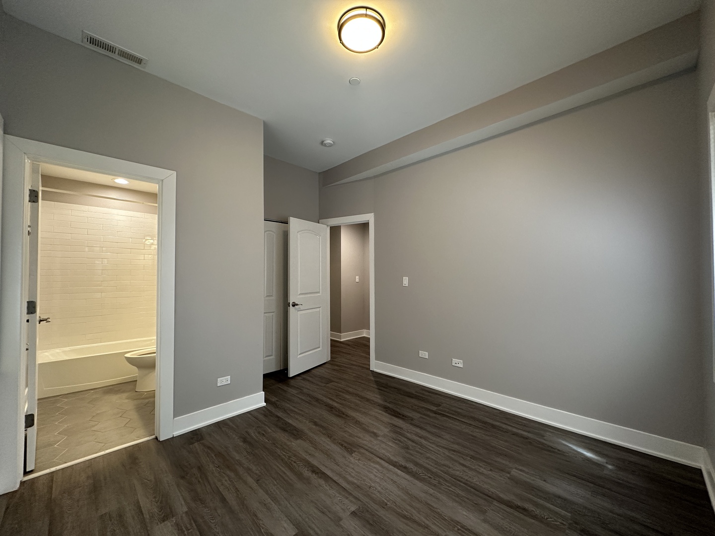 2053 West Iowa Street, Unit 1 Chicago, IL 60622 - Photo 10 of 12 an empty room with wooden floor and windows
