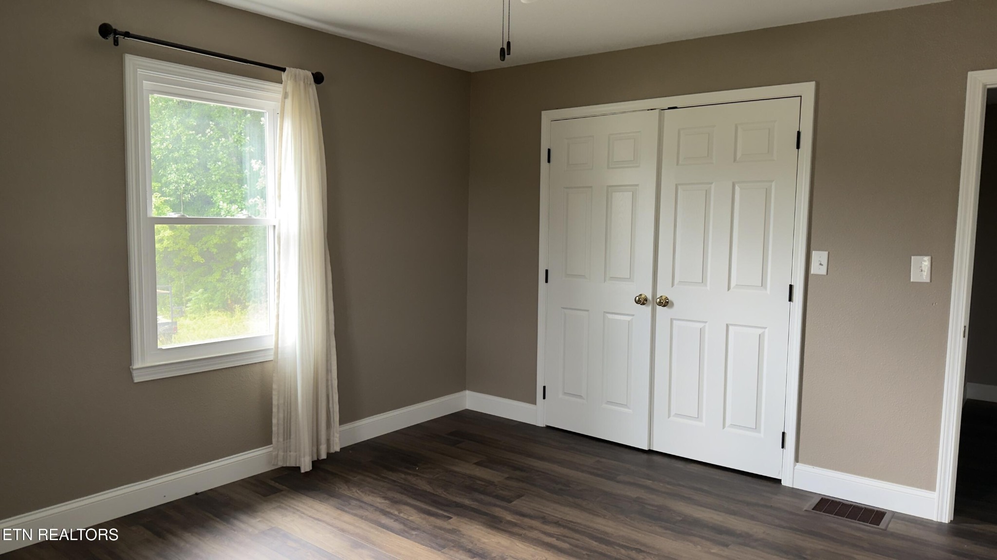 2662 Louisville Road Maryville, TN 37801 - Photo 14 of 60 an empty room with wooden floor and windows