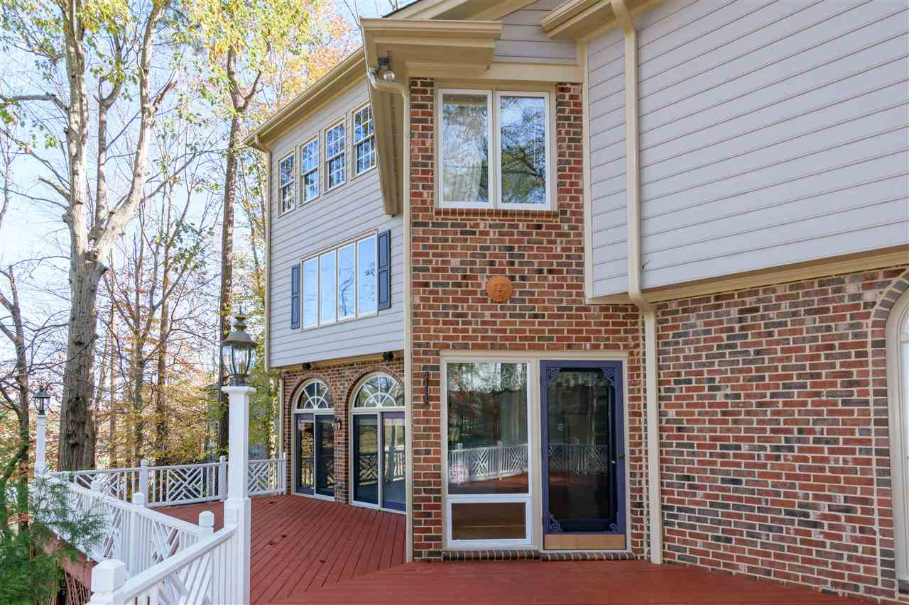 2808 Combe Hill Trail Raleigh, NC 27613 - Photo 3 of 30 Back porch overlooks the golf course with plenty of space for outdoor entertaining and/or relaxing. Beautiful lower garden area. Exterior Back