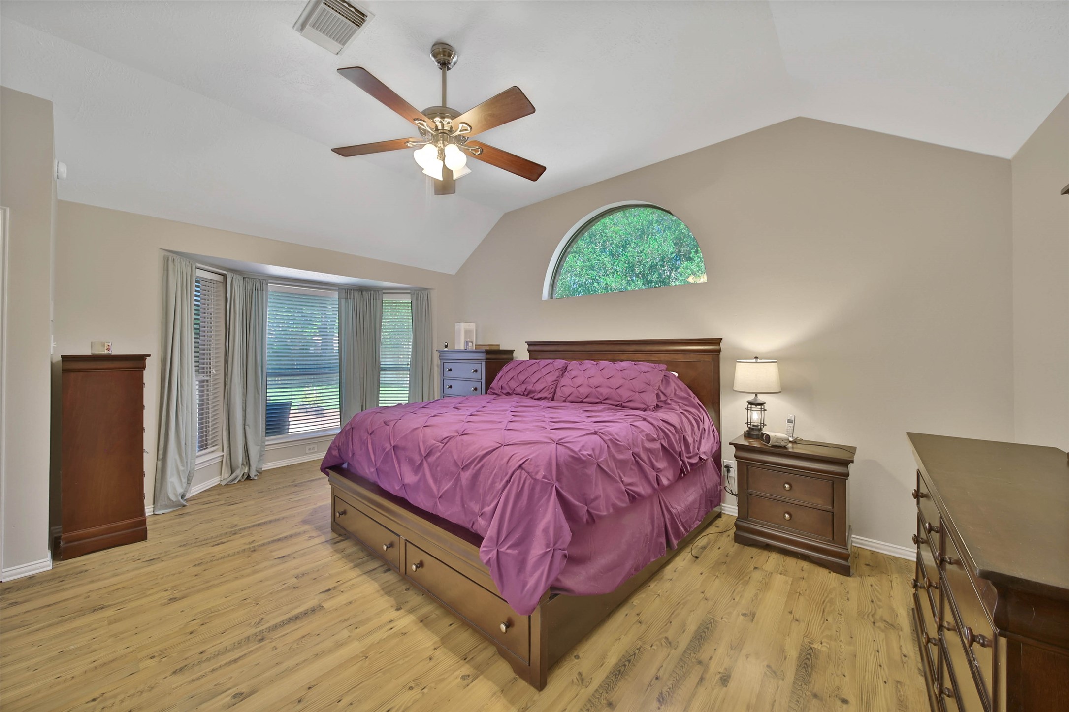 21338 Timber Pines Drive Spring, TX 77388 - Photo 18 of 29 a spacious bedroom with a bed and a chandelier