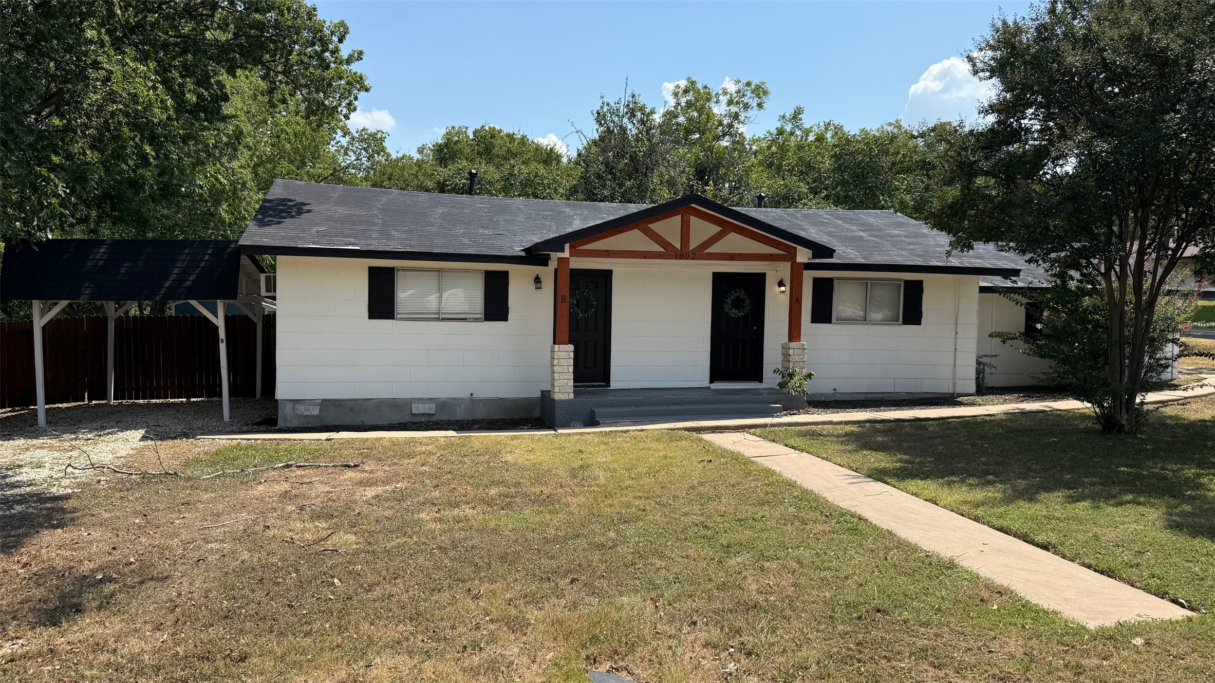 1802 East University Avenue, Unit A Georgetown, TX 78626 - Photo 1 of 23 Single story home with crawl space, roof mounted solar panels, roof with shingles, and a carport