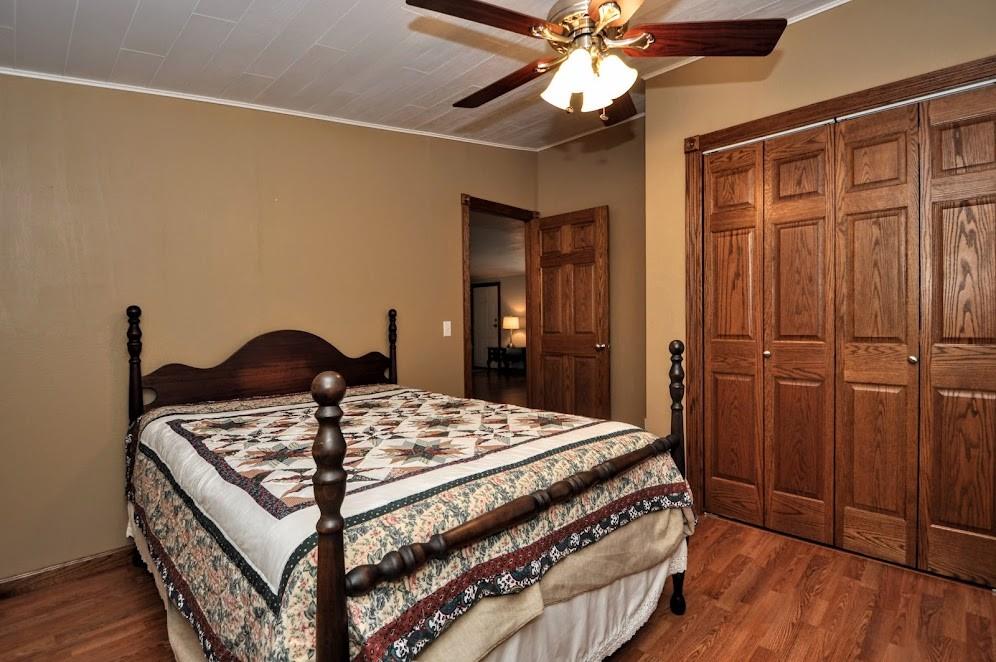 311 Cope Road Perryopolis, PA 15473 - Photo 23 of 47 a bedroom with a bed a dresser and potted plants