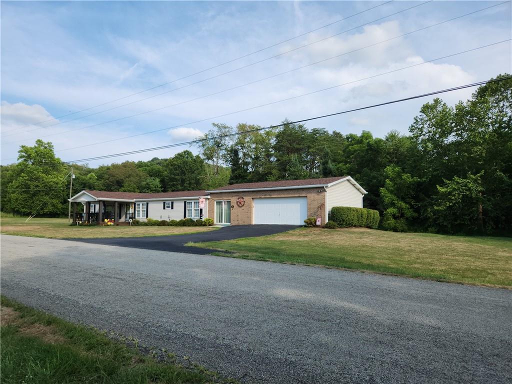311 Cope Road Perryopolis, PA 15473 - Photo 35 of 47 a front view of a house with a yard and garage