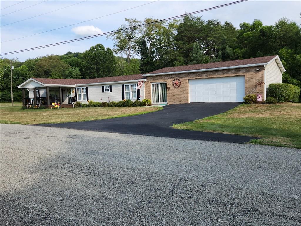 311 Cope Road Perryopolis, PA 15473 - Photo 36 of 47 a front view of a house with a yard and garage