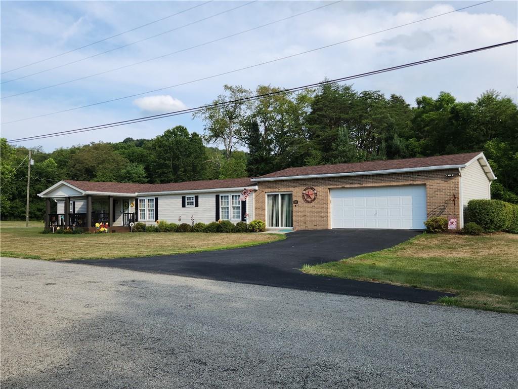 311 Cope Road Perryopolis, PA 15473 - Photo 37 of 47 a front view of a house with a yard and garage