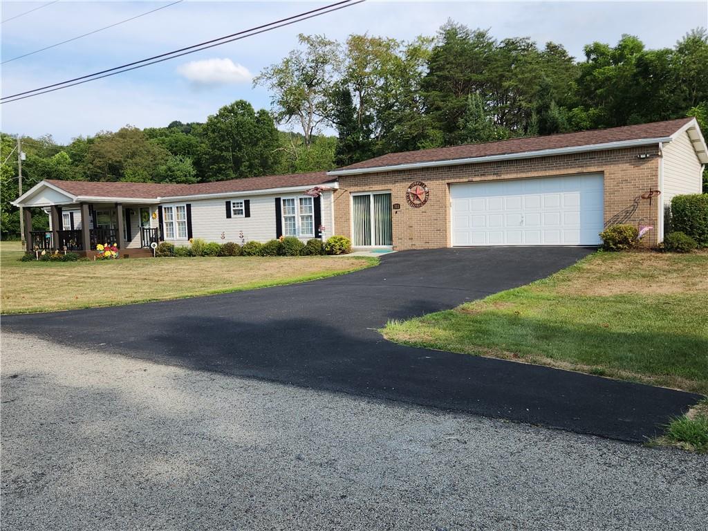 311 Cope Road Perryopolis, PA 15473 - Photo 38 of 47 a view of a yard in front of a house with large trees