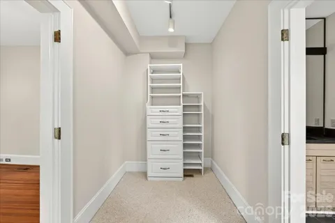 a view of walk in closet with empty racks