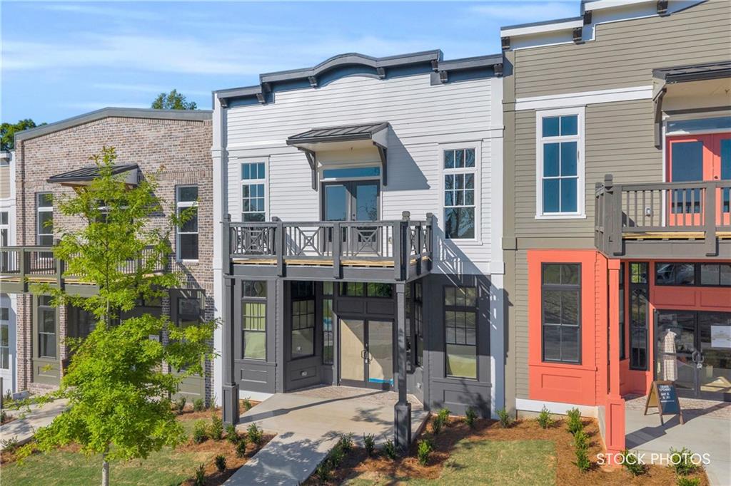 1038 Homestead Way Street Dacula, GA 30019 - Photo 2 of 36 a front view of a house with plants