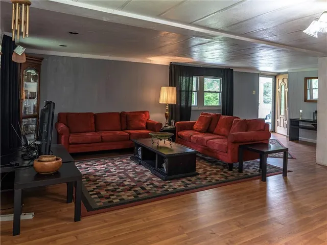a living room with furniture rug and wooden floor