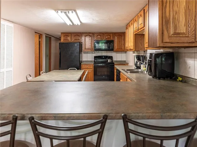a kitchen with stainless steel appliances a table and chairs in it