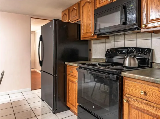 a kitchen with stainless steel appliances granite countertop a stove and a refrigerator with cabinets