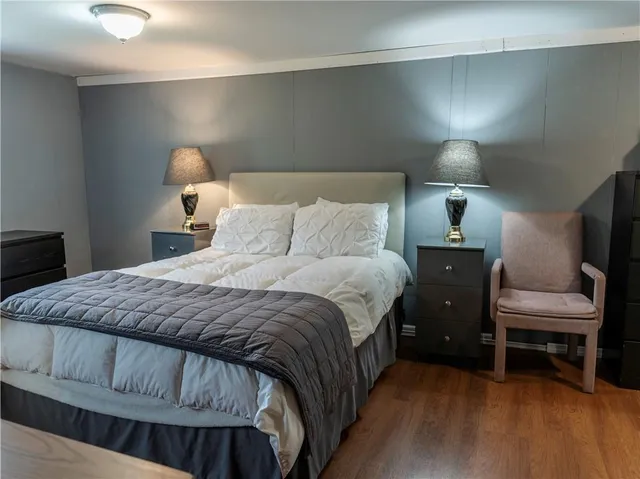 a bedroom with a bed and a chair