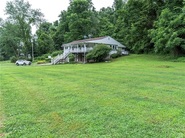 a view of a house with a backyard