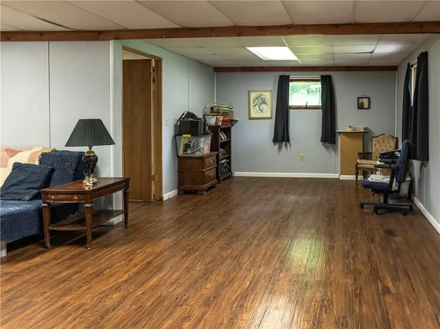 a view of a workspace with furniture and wooden floor