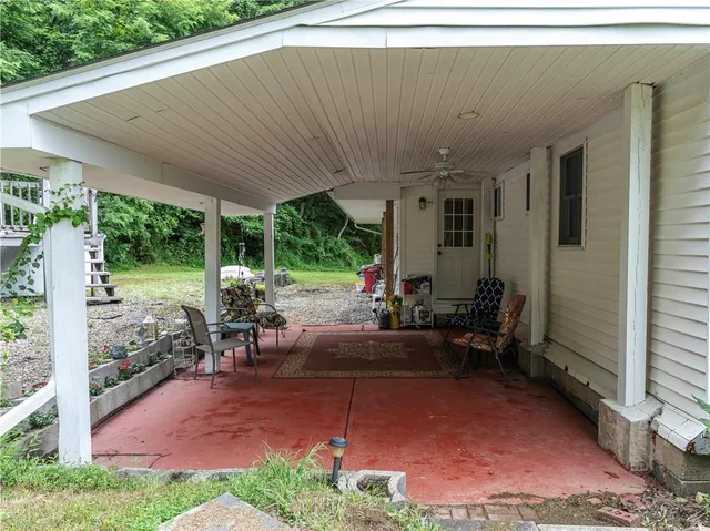 a view of a patio with table and chairs potted plants with wooden fence