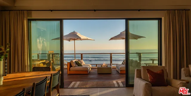 a balcony with furniture and a table