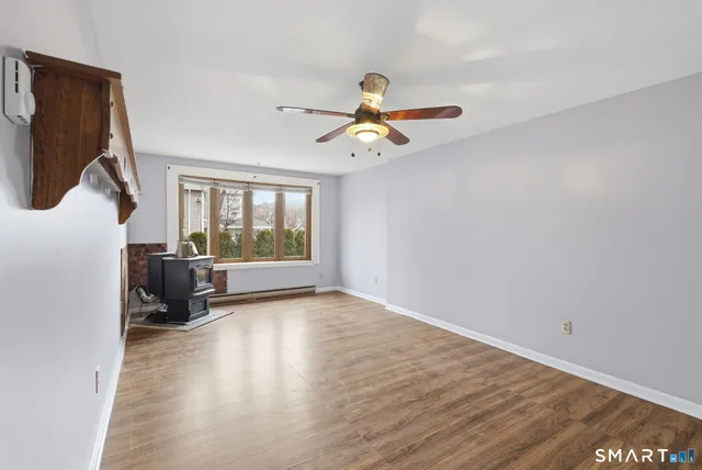 a view of a room with wooden floor ceiling fan