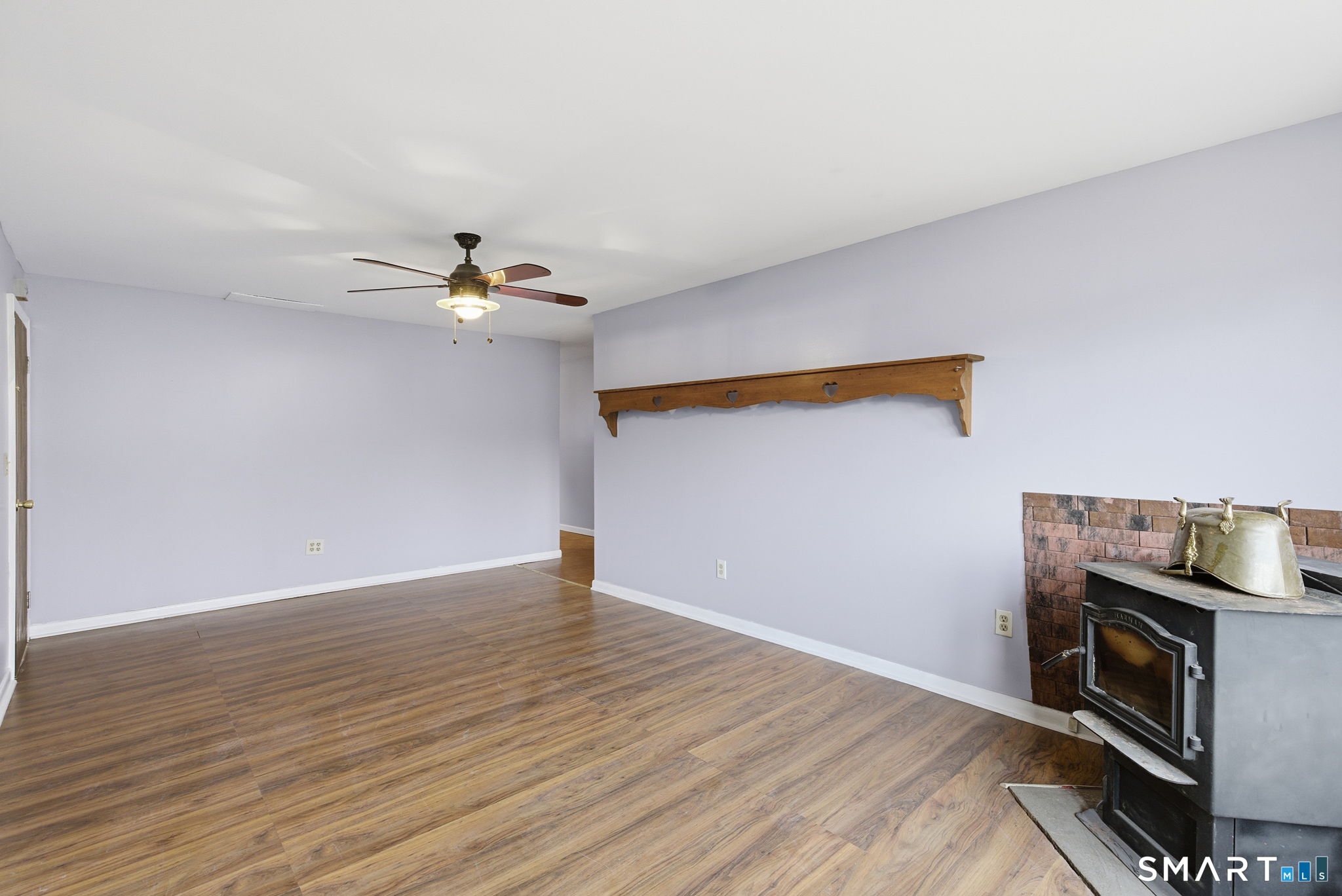 44 East Cedar Street Newington, CT 06111 - Photo 19 of 26 a view of an empty room with wooden floor and a fireplace