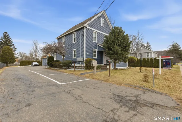 a view of a house with a snow on the road