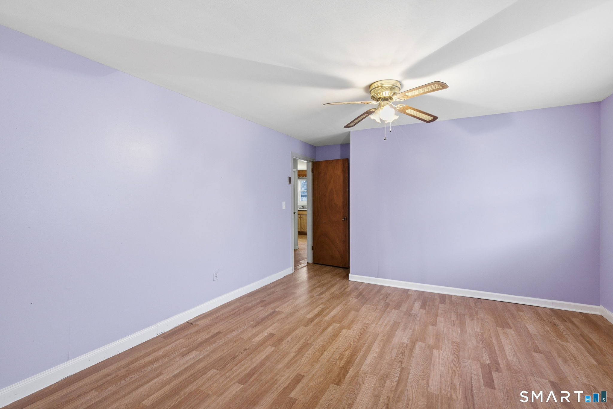 44 East Cedar Street Newington, CT 06111 - Photo 23 of 26 a view of a room with wooden floor and a ceiling fan