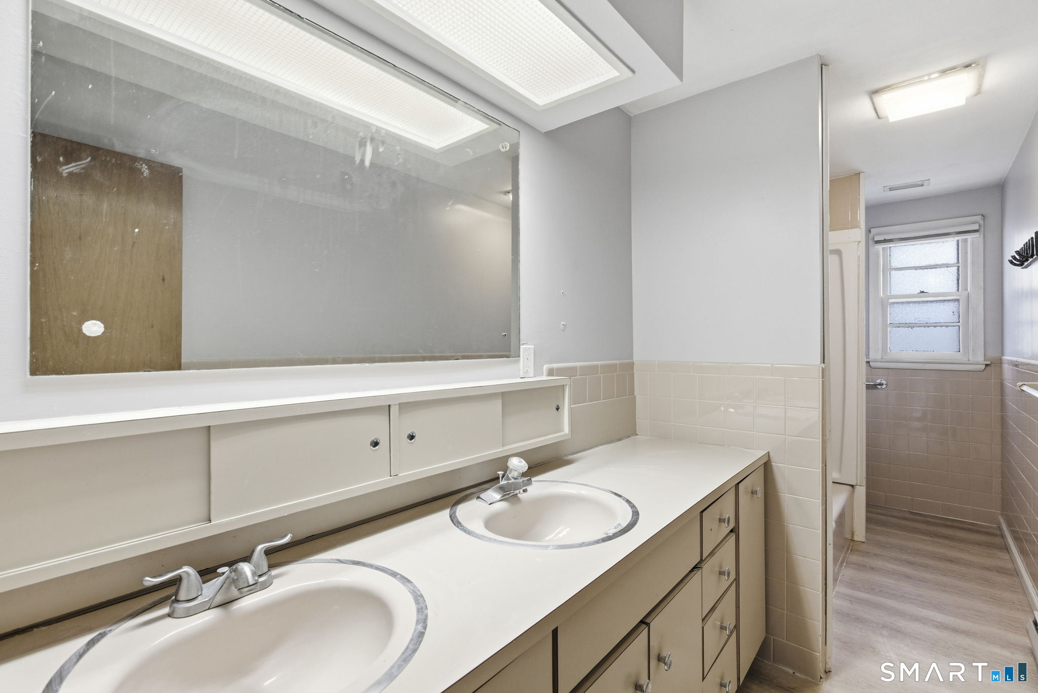 44 East Cedar Street Newington, CT 06111 - Photo 25 of 26 a bathroom with a double vanity sink and a mirror