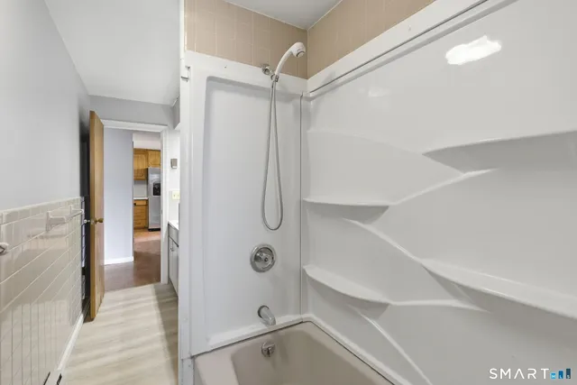 a bathroom with a shower and a glass door