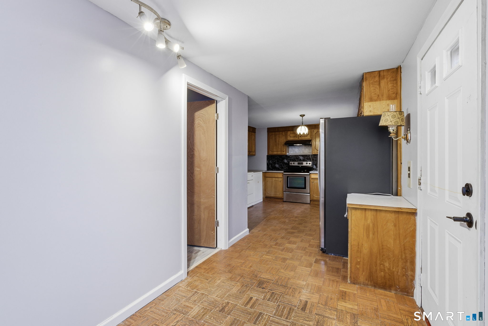 44 East Cedar Street Newington, CT 06111 - Photo 5 of 26 a view of a kitchen with a refrigerator and a stove top oven