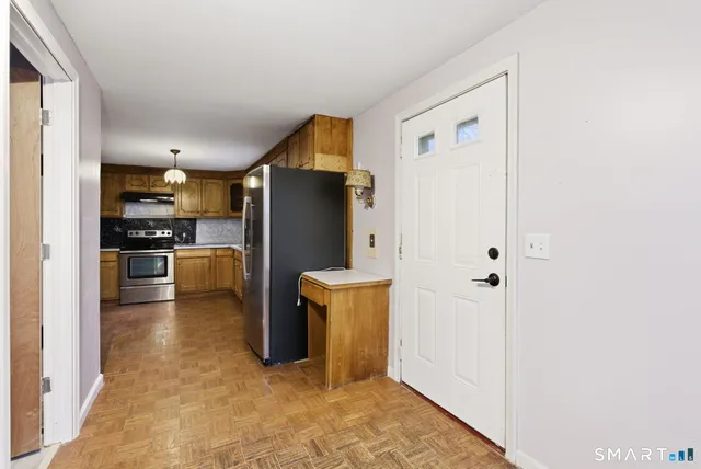 a kitchen with refrigerator and microwave