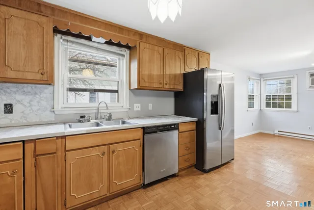 a kitchen with stainless steel appliances granite countertop a refrigerator and a sink