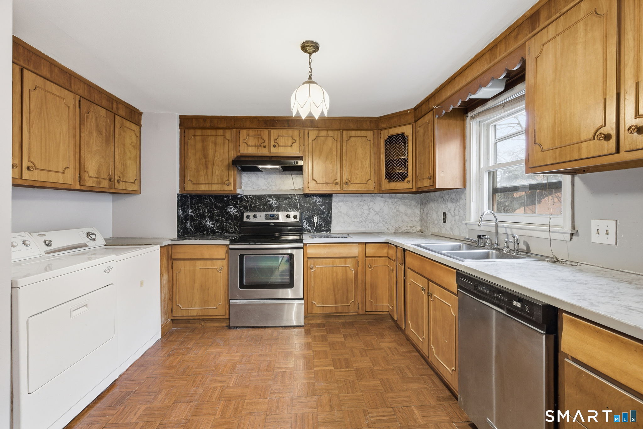 44 East Cedar Street Newington, CT 06111 - Photo 10 of 26 a kitchen with granite countertop a sink stainless steel appliances and cabinets