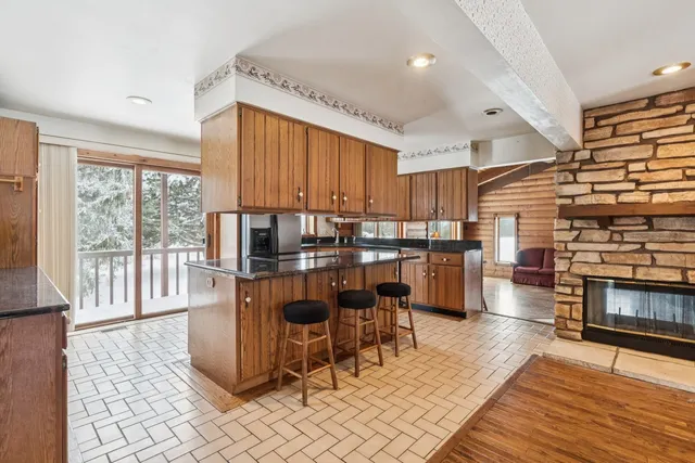 a kitchen with stainless steel appliances granite countertop a sink a stove and cabinets