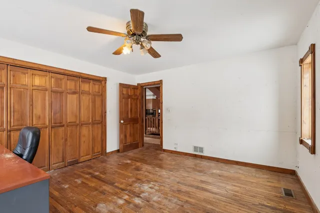 a view of a porch with wooden floor and windows