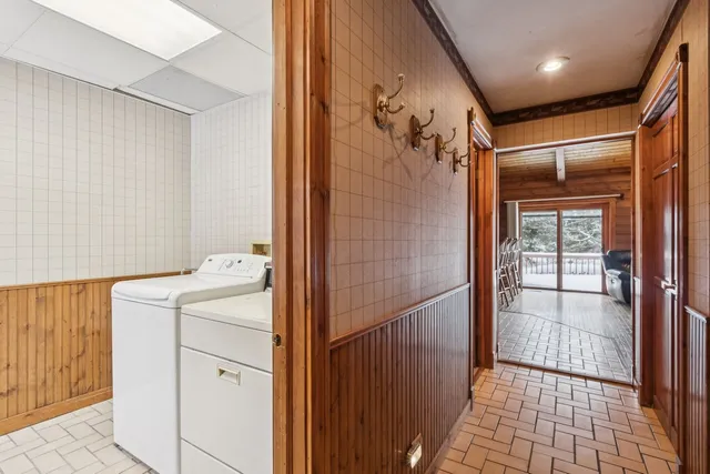 a spacious bedroom with a large bed and a chandelier