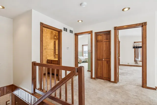 a view of a balcony with wooden floor and fence