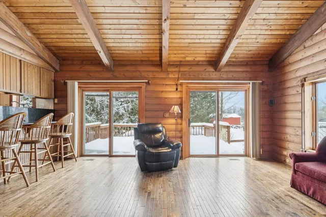 a view of a patio with table and chairs with wooden floor and fence