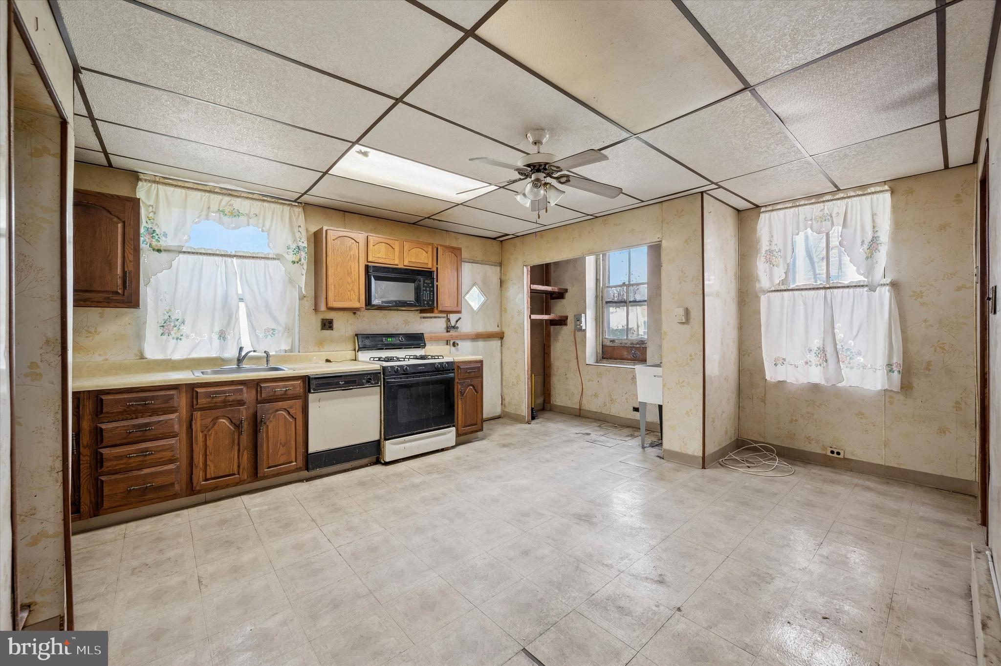 4511 Chester Avenue Philadelphia, PA 19143 - Photo 14 of 35 a large kitchen with stainless steel appliances granite countertop a stove a sink dishwasher and a oven