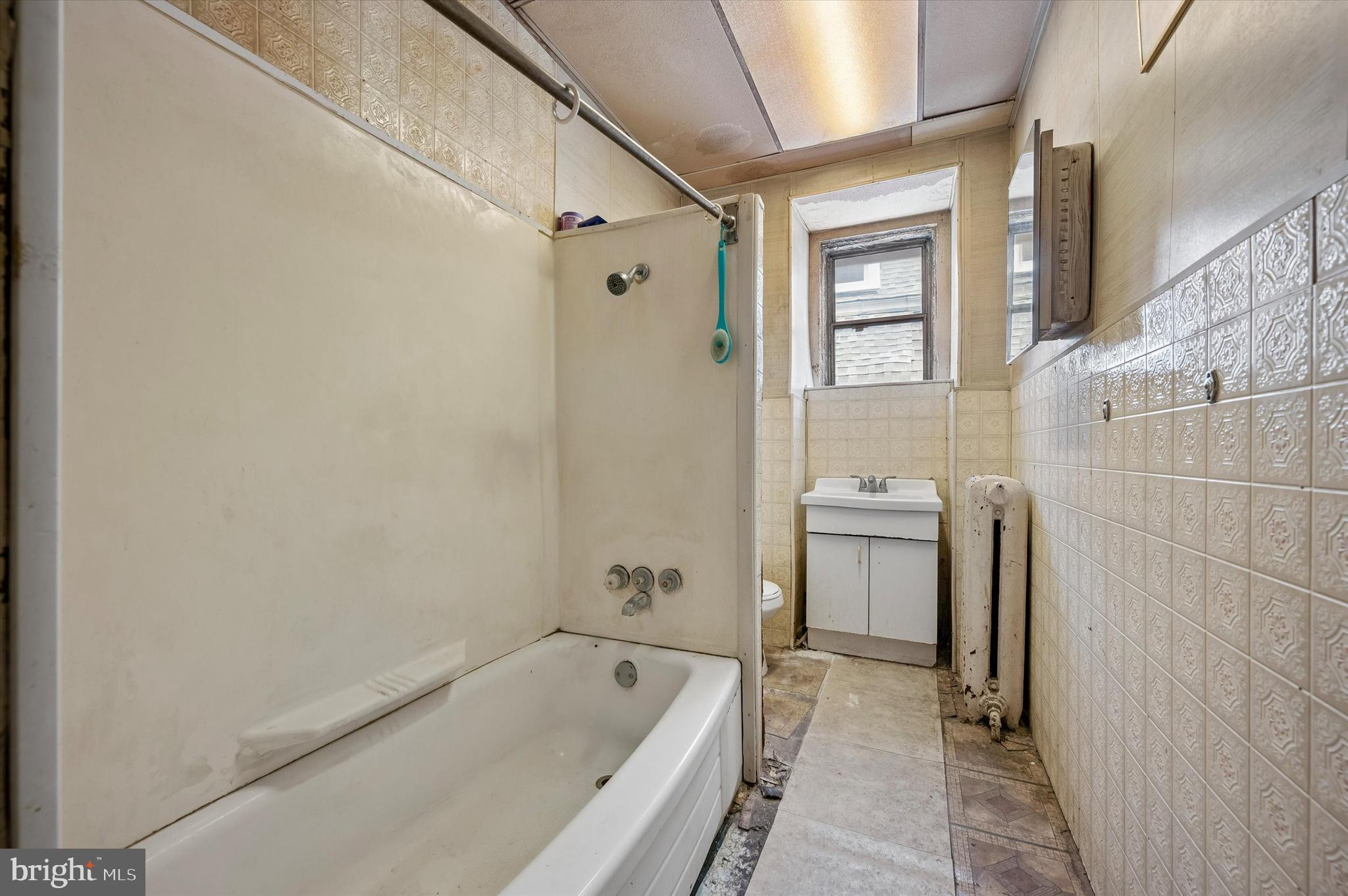 4511 Chester Avenue Philadelphia, PA 19143 - Photo 28 of 35 a bathroom with a tub a sink and a shower