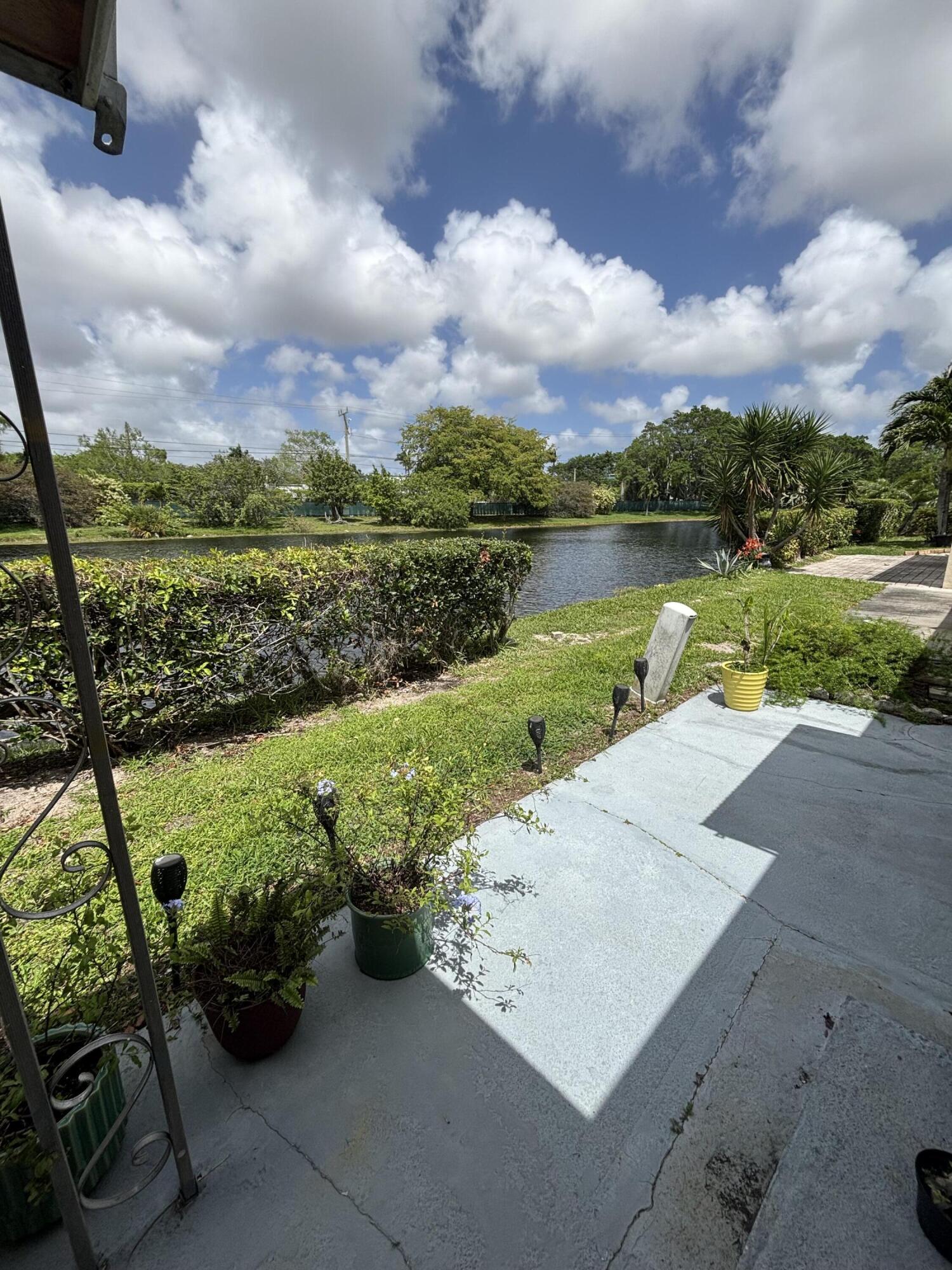 8833 Bella Vista Drive, Unit 8833 Boca Raton, FL 33433 - Photo 17 of 47 a view of a lake with a floor to ceiling yard next to a building